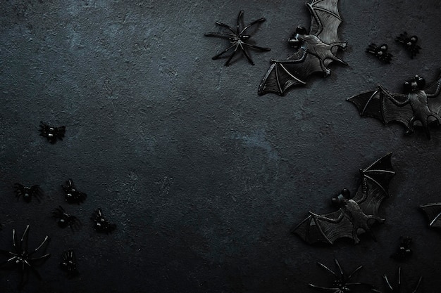 Happy Halloween black background with bats and spiders with copy space