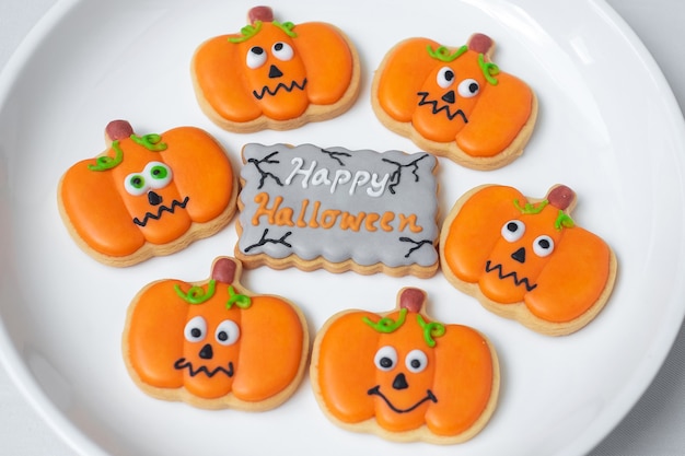 Happy Halloween day with funny Cookies, different Pumpkin biscuits on plate. Trick or Threat, Hello October, fall autumn, Traditional, party and holiday concept