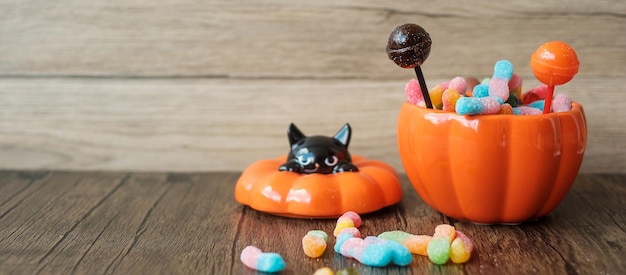 Happy halloween day with ghost candies pumpkin bowl jack o\
lantern and decorative selective focus trick or threat hello\
october fall autumn festive party and holiday concept