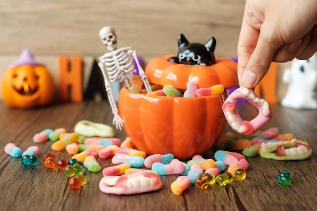 Happy Halloween day with ghost candies pumpkin bowl Jack O lantern and decorative selective focus Trick or Threat Hello October fall autumn Festive party and holiday concept