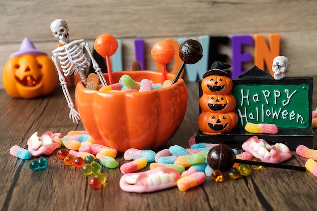 Happy halloween day with ghost candies pumpkin bowl jack o lantern and decorative selective focus trick or threat hello october fall autumn festive party and holiday concept