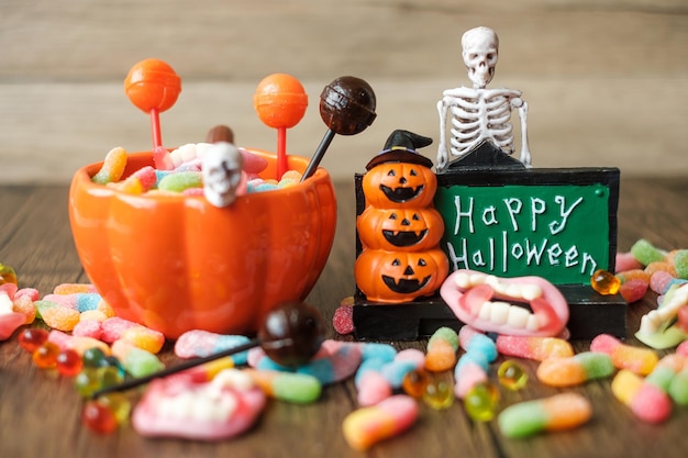 Happy Halloween day with ghost candies pumpkin bowl Jack O lantern and decorative selective focus Trick or Threat Hello October fall autumn Festive party and holiday concept