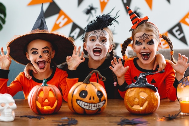 Happy Halloween een groep kinderen in pakken en met pompoenen in huis