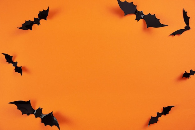 Happy halloween flat lay mockup with black bats on orange background Holiday concept composition