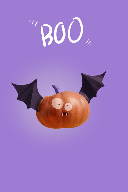 Happy halloween funny pumpkin bat with frightening eyes lettering boo purple background