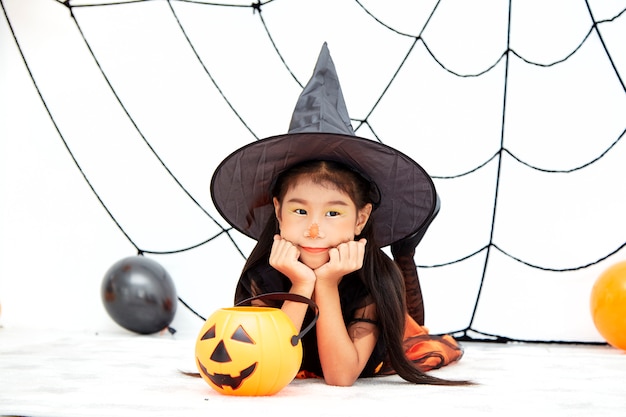 Happy Halloween little witch with a pumpkin