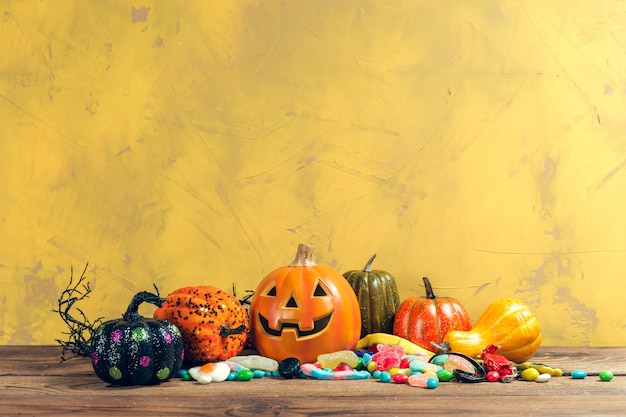 Happy halloween! Pumpkin with candy in the home.