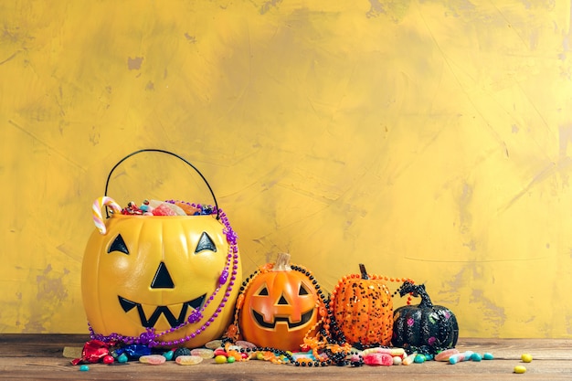 Happy halloween! Pumpkin with candy in the home.