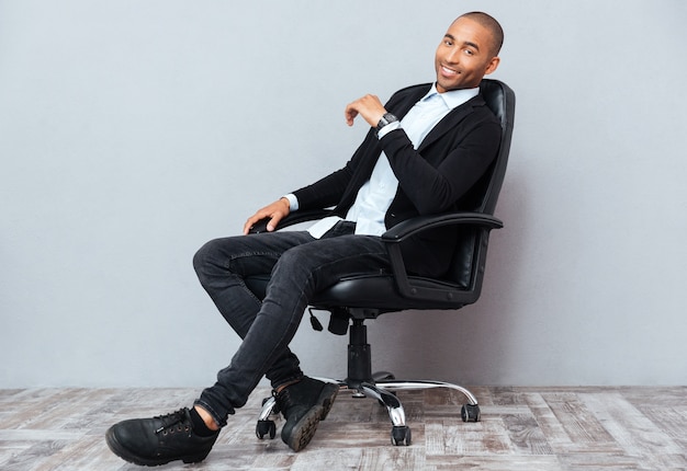 Happy handsome african american young man sitting on