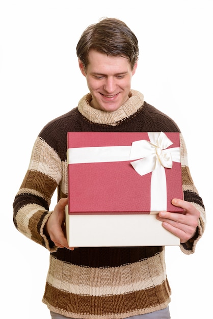 Happy handsome Caucasian man opening gift box ready for Valentin