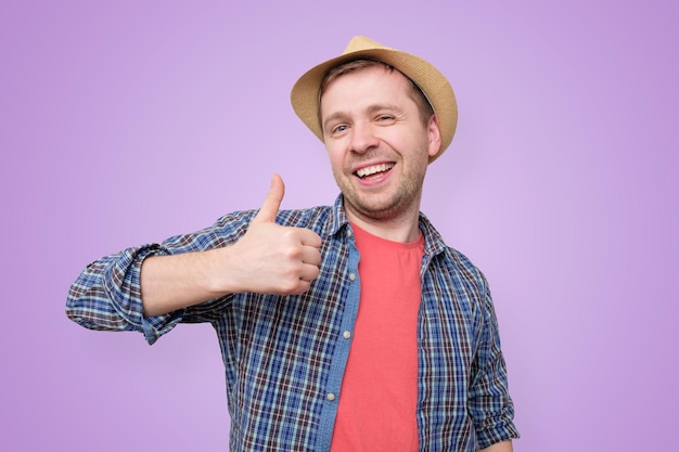 Happy handsome man showing thumbs up studio shot