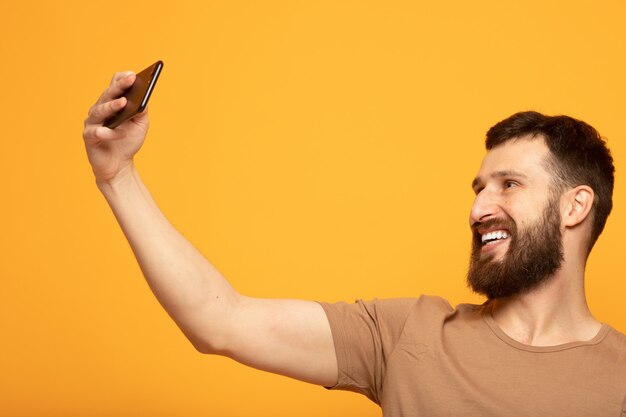 Happy handsome man using a smartphone