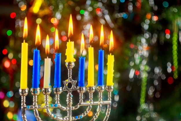 Happy Hanukkah. Low key image of jewish holiday with menorah the night view out focus