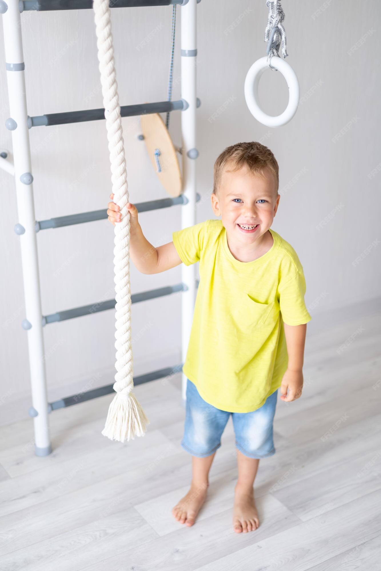 Premium Photo  Happy healthy baby boy does sports on the swedish wall of  the house healthy lifestyle sports at home children's sports complex ladder