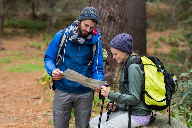 Happy hiker couple looking at map