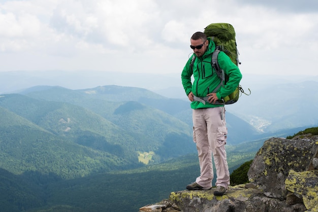 Happy hiker winning reaching life goal success freedom and happiness achievement in mountains