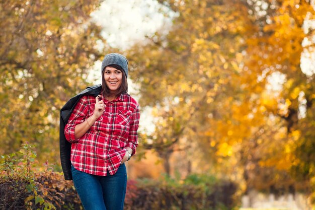 Happy hipster girl in the autumn park