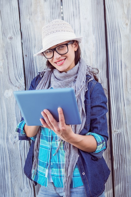 Happy hipster holding a tablet pc