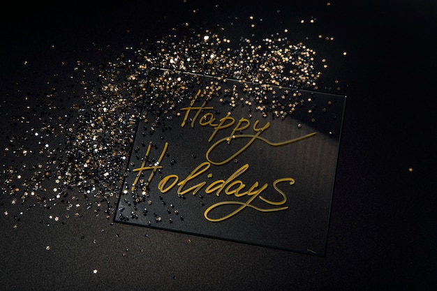 Photo happy holidays beautiful sparkling golden happy holidays on a black background