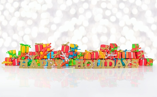 Happy holidays golden text on the background of varicolored gifts on a bokeh background