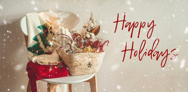 Photo happy holidays. two winter sweaters and christmas decorations