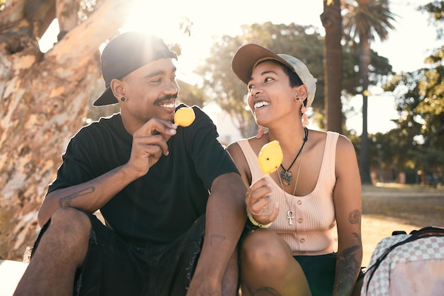 Happy ice cream and couple in nature talking while on an adventure holiday and journey in Mexico Happiness smile and young man and woman eating a dessert while on an outdoor date on vacation