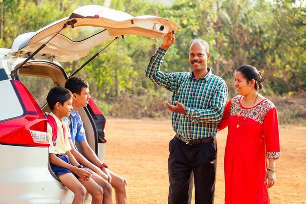 Happy indian family together going to vacation on beach in Goa