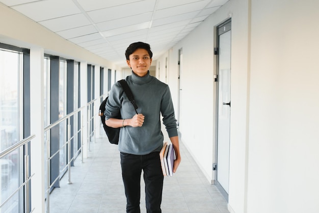 Happy indian male student at the university