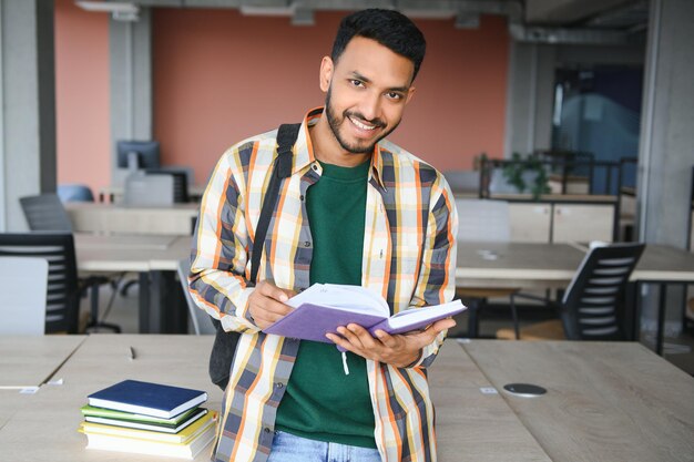 Happy indian male student at the university