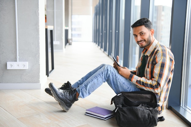 Happy indian male student at the university