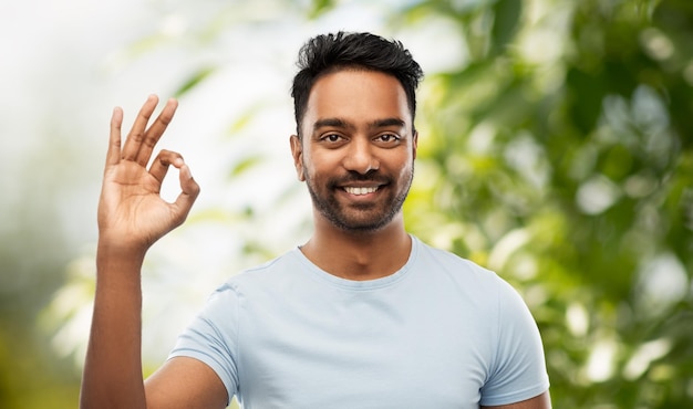 happy indian man in tshirt showing ok hand sign