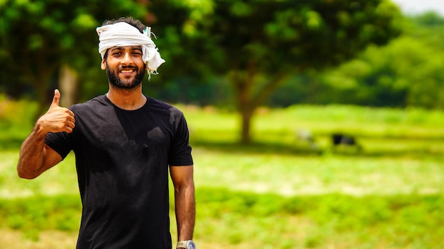 Happy indian young farmer handsome boy in village