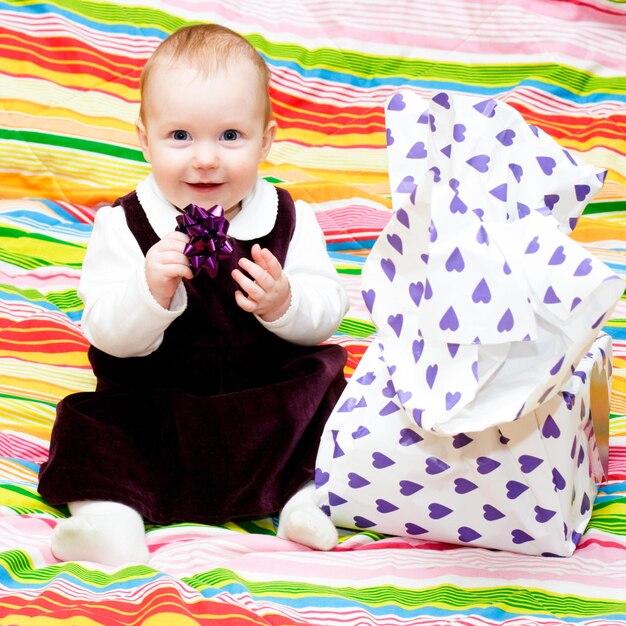 Happy infant with gift