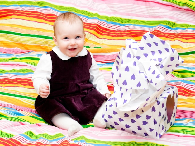 Happy infant with gift