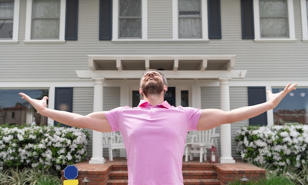 Happy and inspired. for sale. realtor waiting for visitors. rent new home. ownership. confident man outside new american home. successful real estate agent purchasing house for investment purpose.