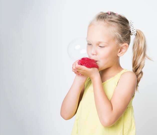 Happy joyful girl playing a red slime