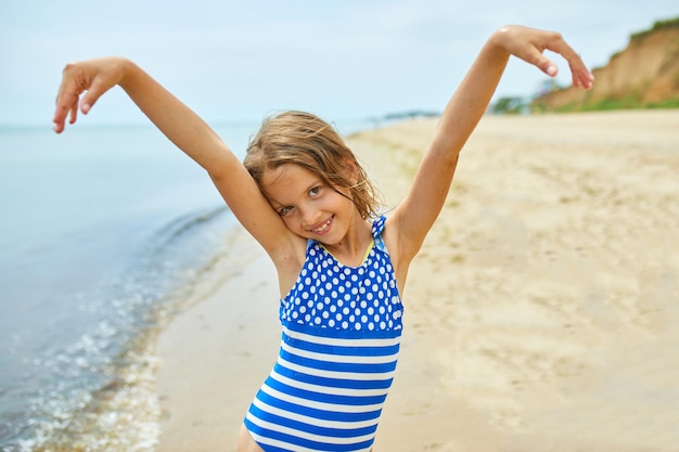 Happy joyful little girl run on the beach