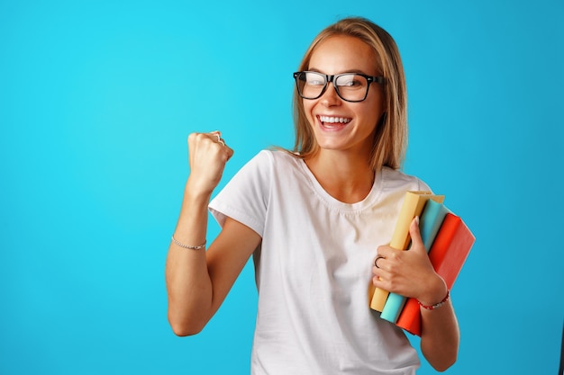 Happy joyful smiling young woman celebrating success