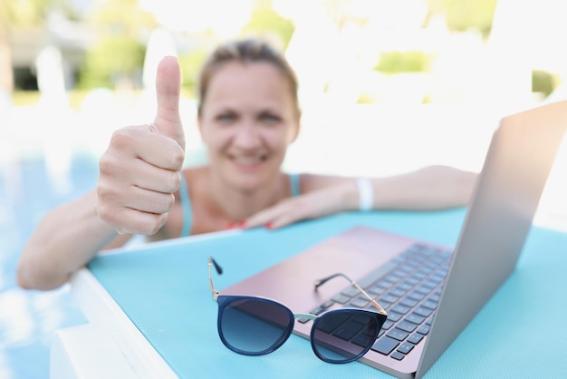 Happy joyful woman show thumbs up on camera relaxed person on summer holiday