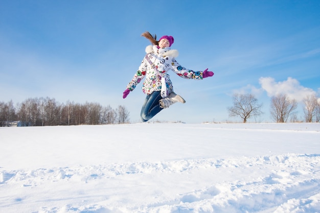 happy jumping girl in winter park