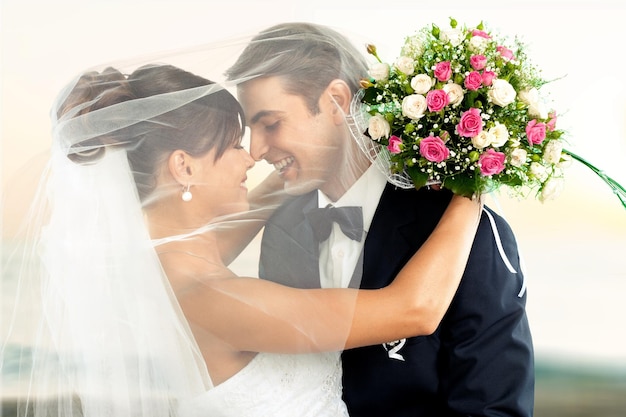 Happy just married young couple  with flowers