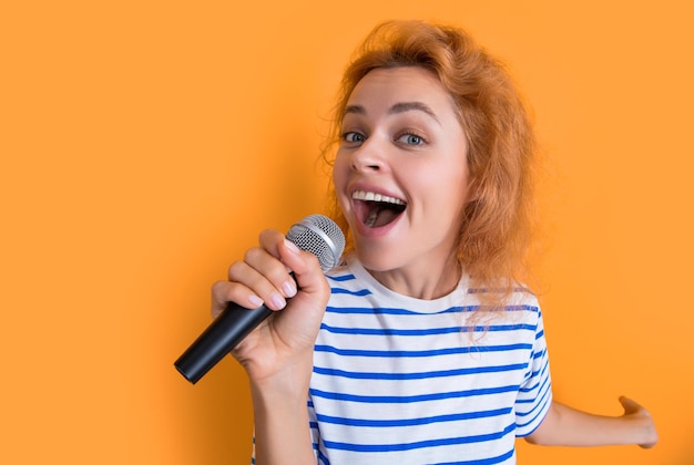 Happy karaoke woman singer isolated on yellow background young singer woman