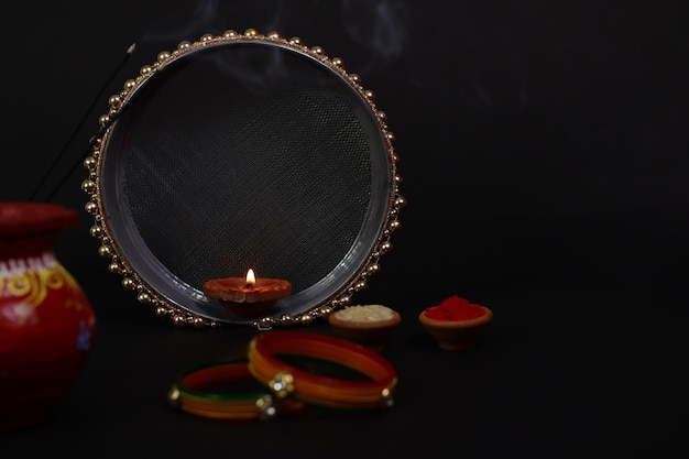 Happy karwa chauth festival , Indian woman performing hindu married festival ritual of karwa chauth