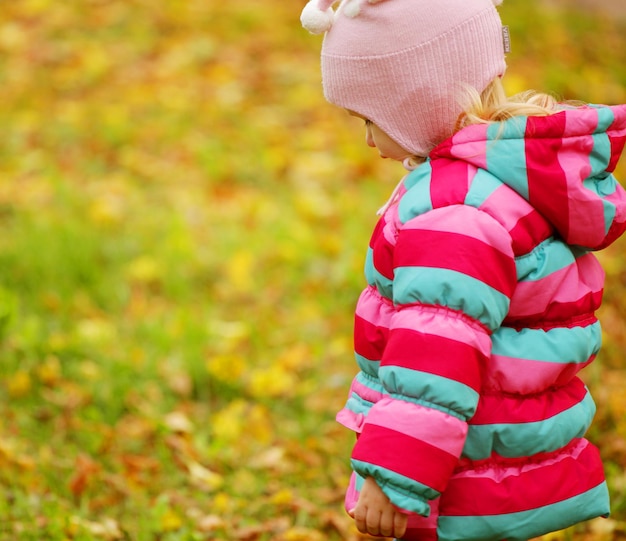 Happy kid in autumn park