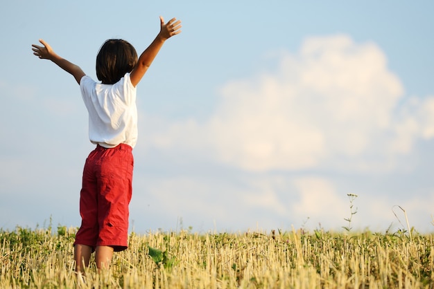 Happy kid on beautiful field