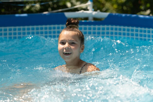 Happy kid enjoy sunny summer day swimming in leisure pool recreation