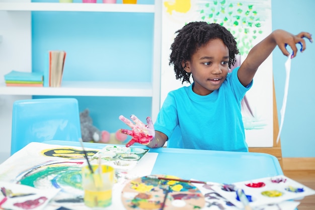 Happy kid enjoying arts and crafts painting