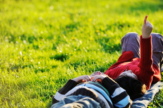 Happy kid enjoying sunny late summer and autumn day in nature\
on green grass