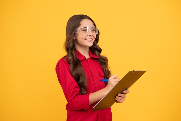 Happy kid girl in eyeglasses hold paper folder education