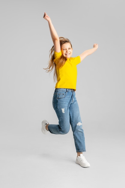 Happy kid girl isolated on white studio background Looks happy cheerful sincere Copyspace Childhood education emotions concept